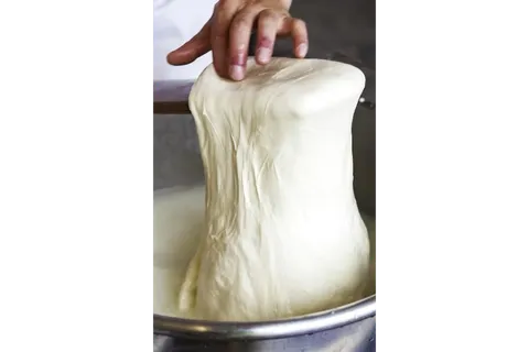 Housemade fior di latte mozzarella being hand-pulled at Cavalli Pizzeria
