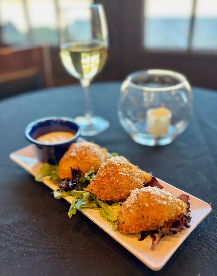 Cavalli's Sicilian rice ball arancini, fried and served with dipping sauce